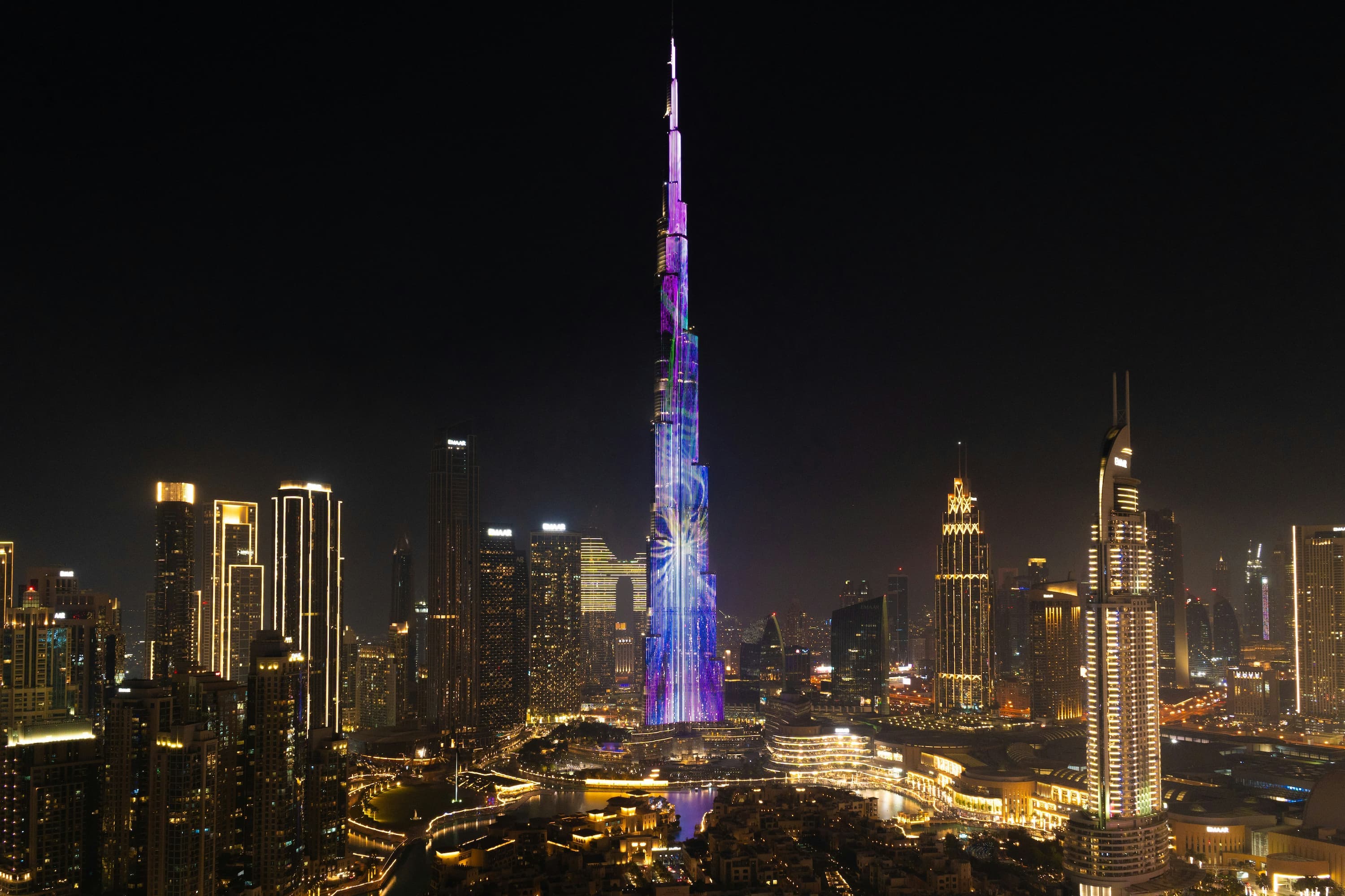 The Burj Khalifa illuminated at night above Downtown Dubai